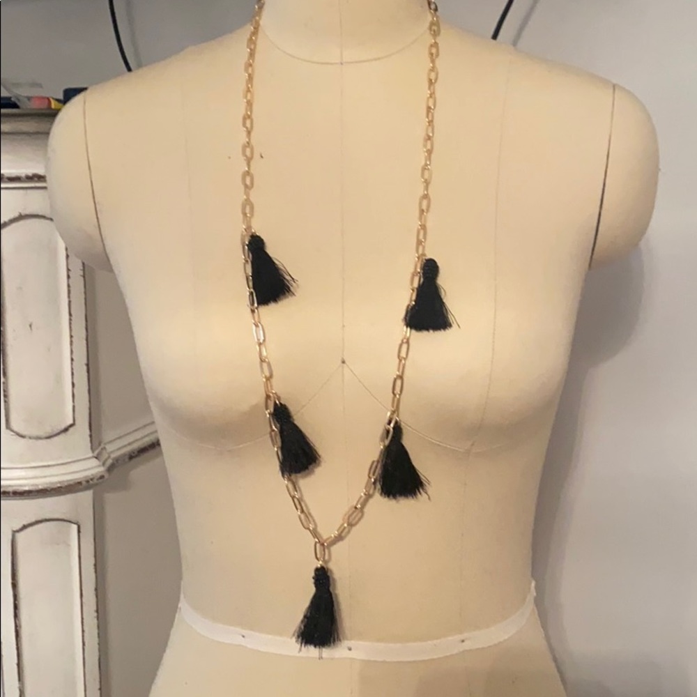 Long gold necklace with black tassels